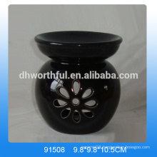 Handmade black ceramic aroma burner with flower shaped hollow-out design
